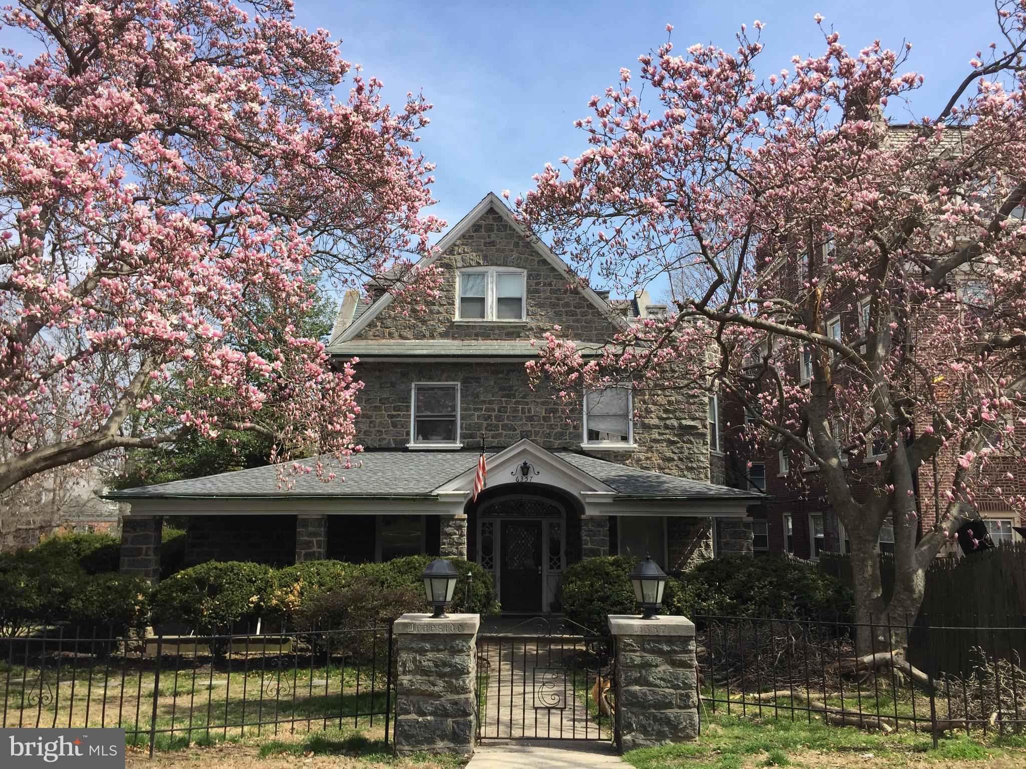6357 Lancaster Avenue Philadelphia, PA 19151 - Photo 1 of 27 a front view of a house with a small yard and large tree