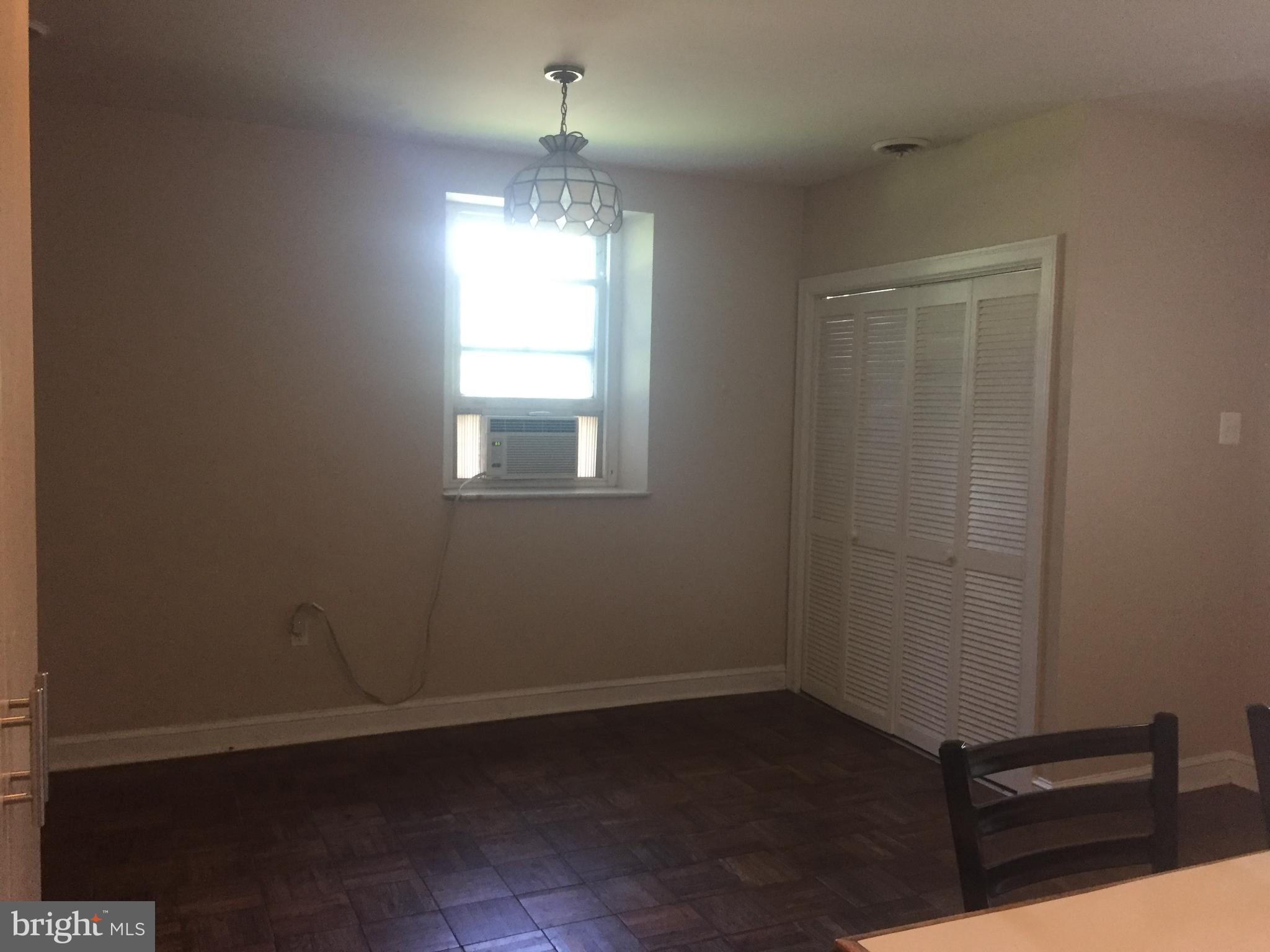 6357 Lancaster Avenue Philadelphia, PA 19151 - Photo 11 of 27 an empty room with wooden floor fan and window