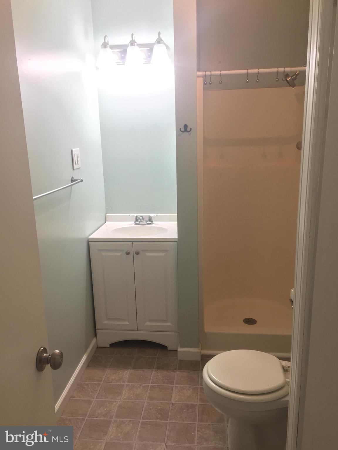 6357 Lancaster Avenue Philadelphia, PA 19151 - Photo 17 of 27 a bathroom with a sink a toilet and a mirror