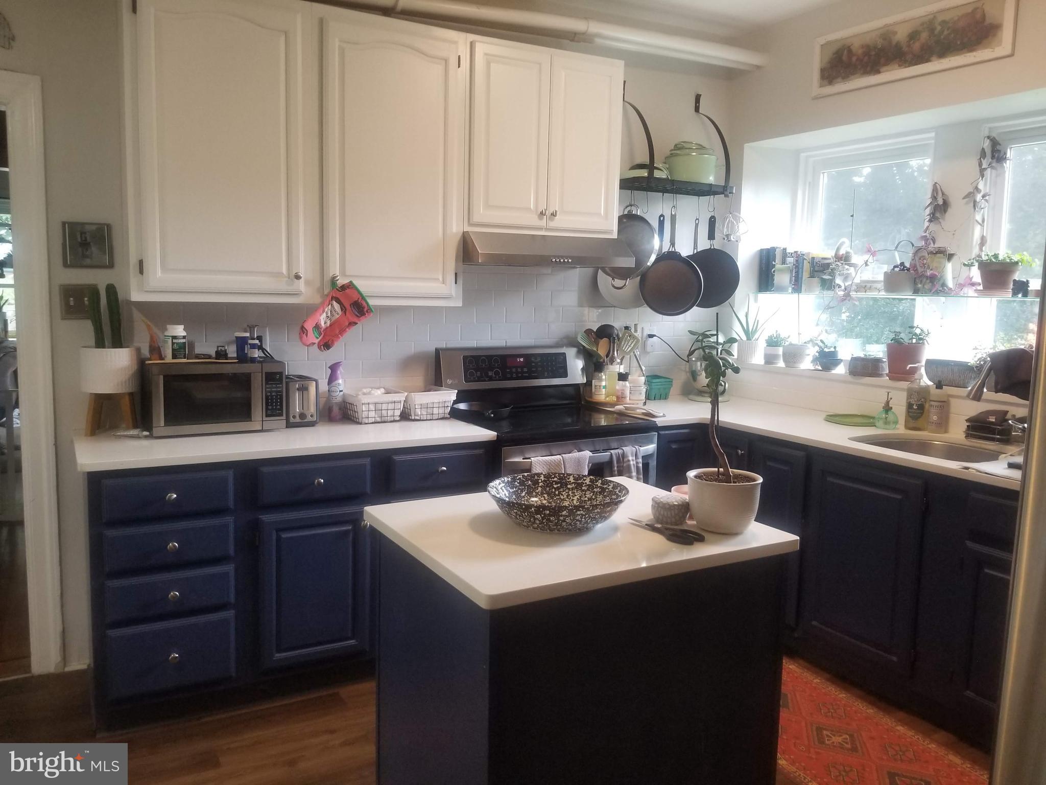 6357 Lancaster Avenue Philadelphia, PA 19151 - Photo 21 of 27 a kitchen with a sink cabinets and wooden floor