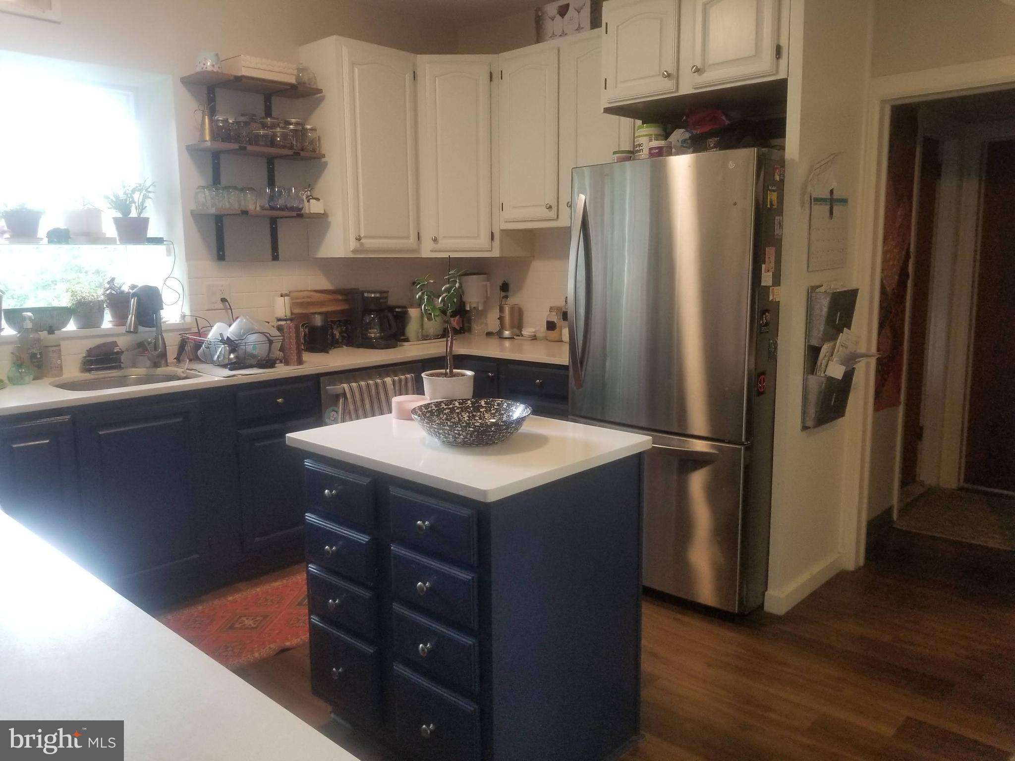 6357 Lancaster Avenue Philadelphia, PA 19151 - Photo 22 of 27 a kitchen with a sink a refrigerator and cabinets