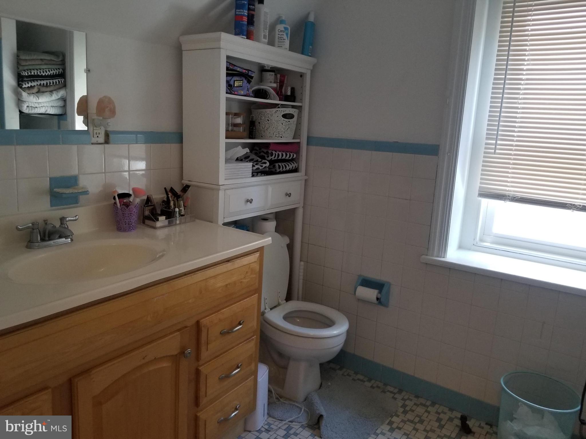 6357 Lancaster Avenue Philadelphia, PA 19151 - Photo 27 of 27 a bathroom with a sink a toilet and a window