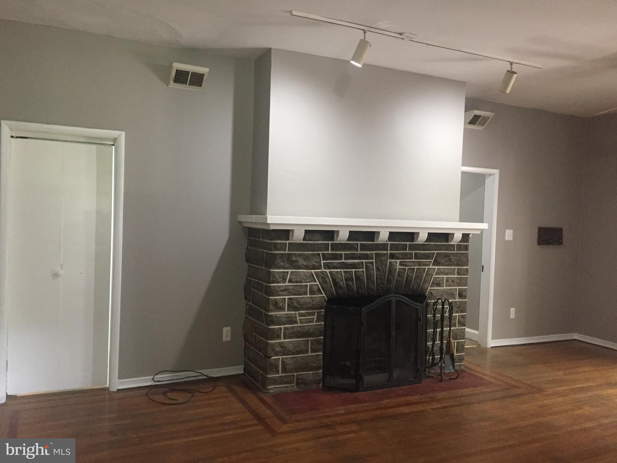 6357 Lancaster Avenue Philadelphia, PA 19151 - Photo 3 of 27 a view of a livingroom with wooden floor and a fireplace