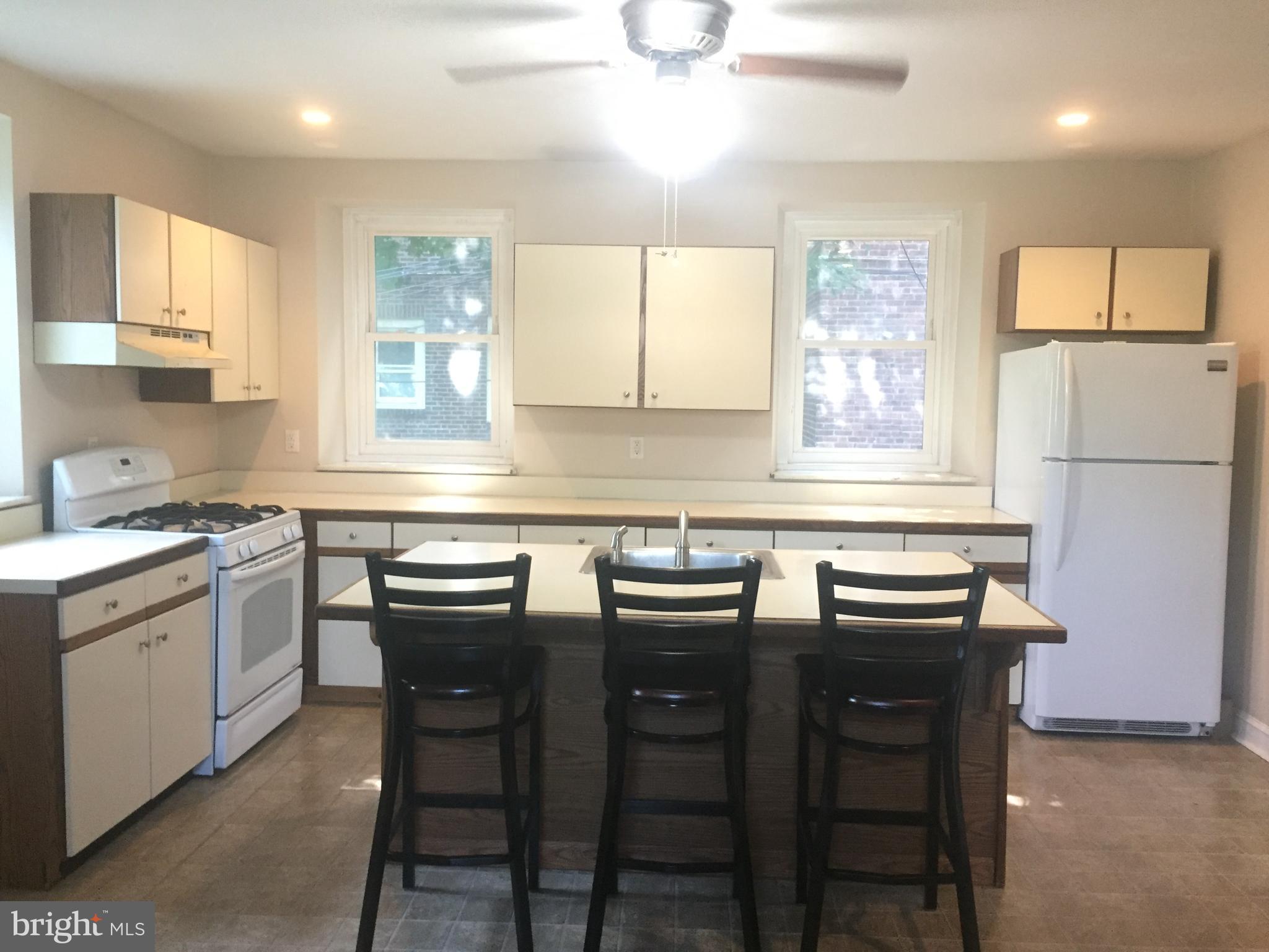 6357 Lancaster Avenue Philadelphia, PA 19151 - Photo 8 of 27 a kitchen with granite countertop cabinets sink and white appliances