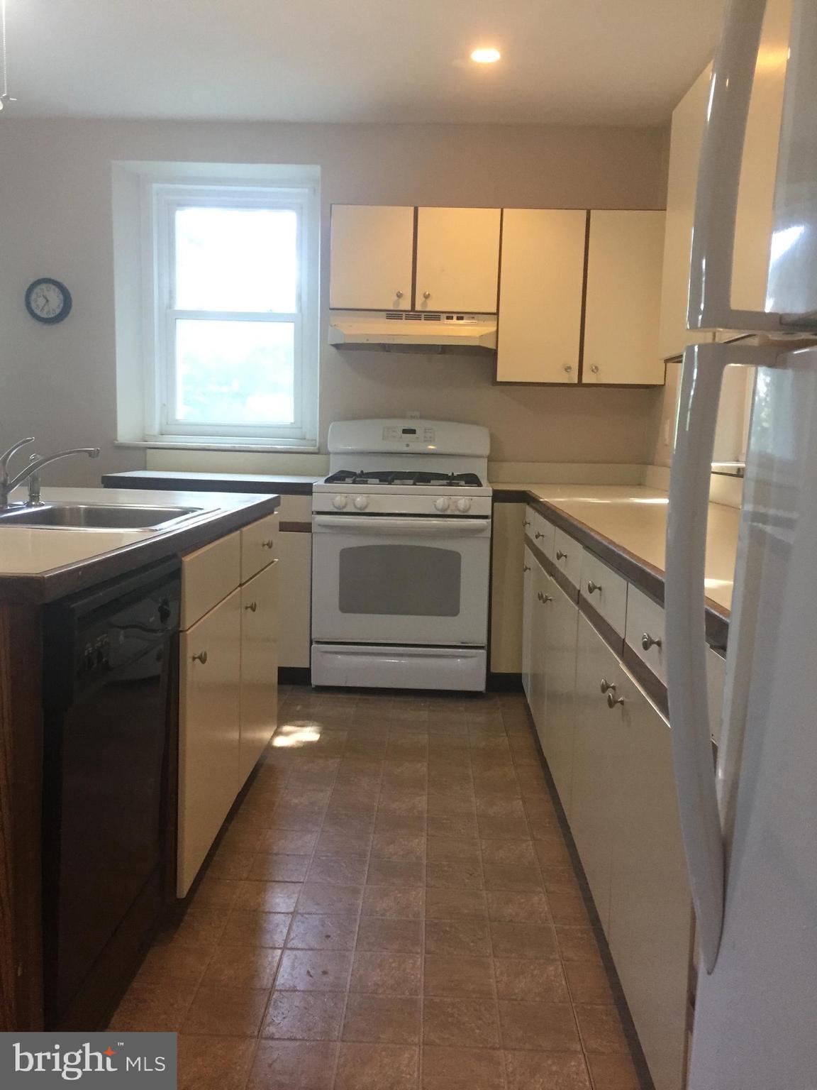 6357 Lancaster Avenue Philadelphia, PA 19151 - Photo 9 of 27 a kitchen with a sink stove and cabinets