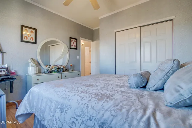 a bedroom with a bed and a chandelier