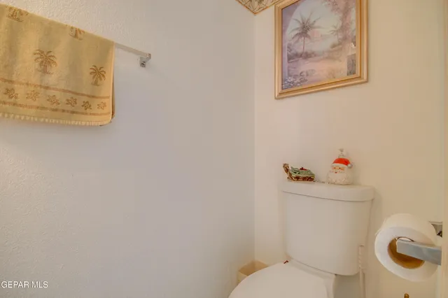 a kitchen with stainless steel appliances granite countertop a stove a refrigerator a white table and chairs with wooden floors