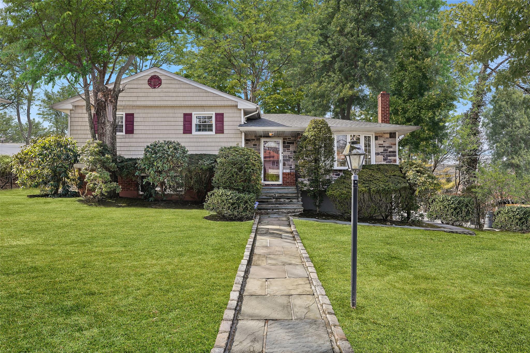 1 Skytop Road Scarsdale, NY 10583 - Photo 1 of 1 Tri-level home with a front yard, roof with shingles, and a chimney