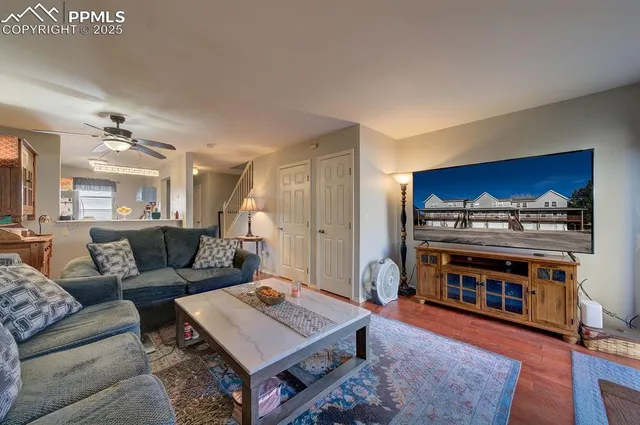 a living room with furniture a fireplace and kitchen view