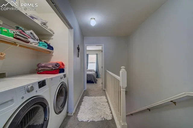 a view of storage and utility room with washer and dryer