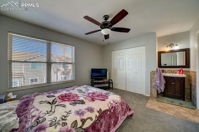 a bedroom with a bed and a television