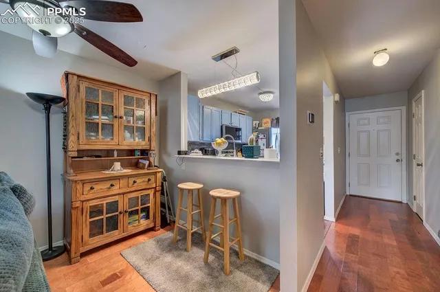 a view of a kitchen with kitchen island granite countertop a refrigerator and a stove
