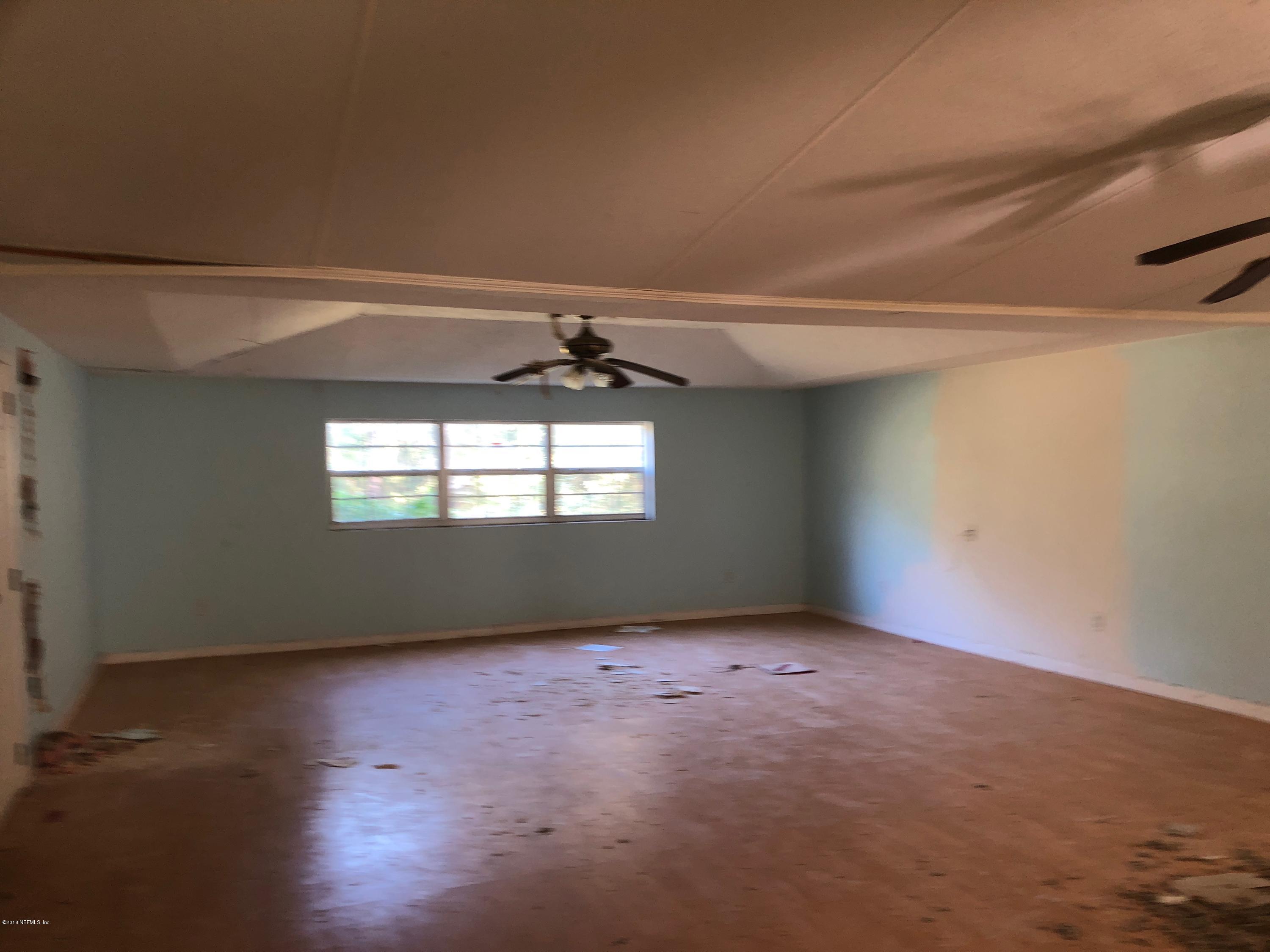 7140 Northeast 192 Place Citra, FL 32113 - Photo 10 of 10 an empty room with wooden floor and windows