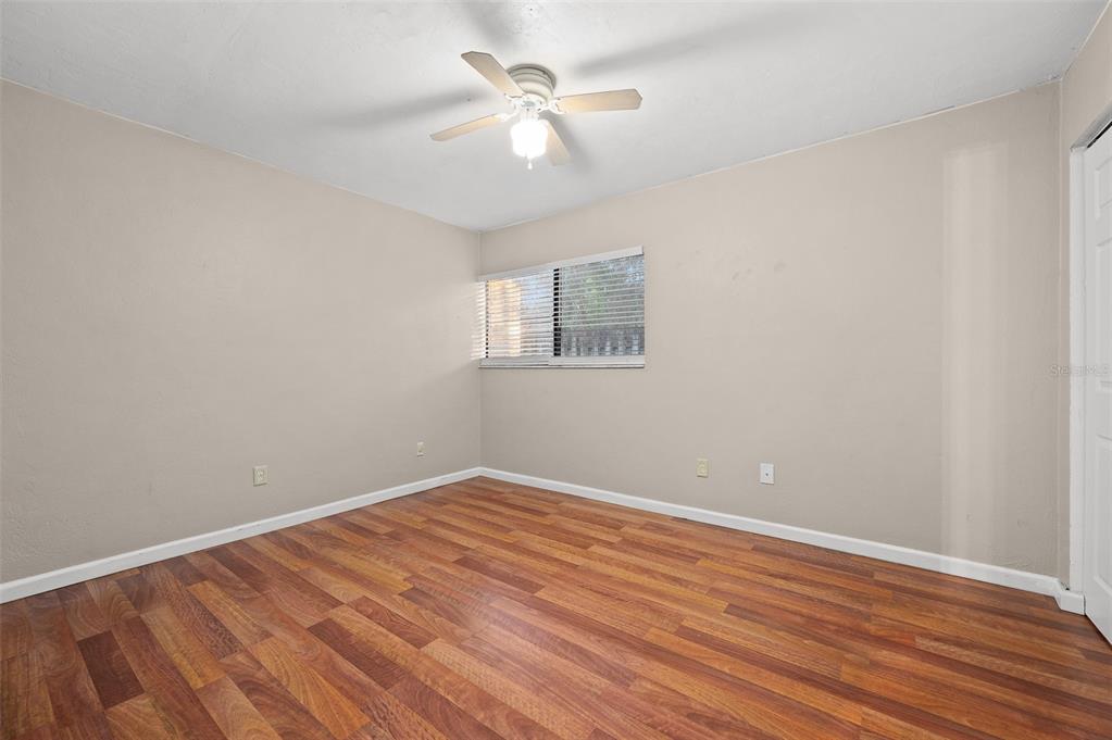 2508 Southwest 35th Place, Unit 151 Gainesville, FL 32608 - Photo 12 of 19 wooden floor in an empty room with a window