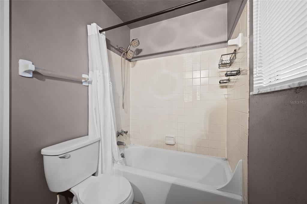 2508 Southwest 35th Place, Unit 51 Gainesville, FL 32608 - Photo 14 of 20 a bathroom with a toilet and a shower