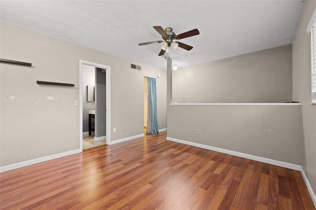 2508 Southwest 35th Place, Unit 51 Gainesville, FL 32608 - Photo 16 of 20 a view of an empty room with wooden floor