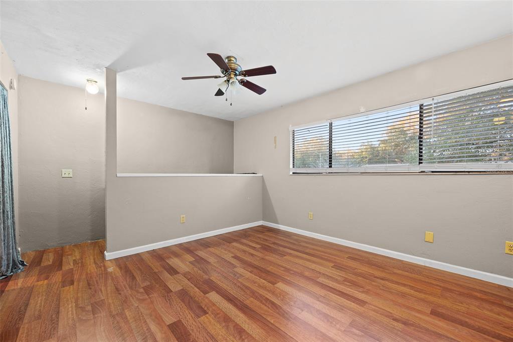 2508 Southwest 35th Place, Unit 51 Gainesville, FL 32608 - Photo 17 of 20 a view of empty room with wooden floor and fan