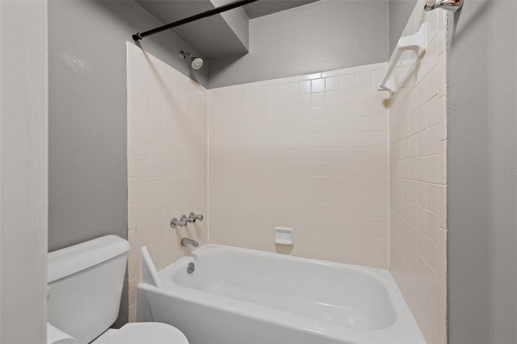 2508 Southwest 35th Place, Unit 51 Gainesville, FL 32608 - Photo 18 of 20 a bathroom with a bathtub and shower