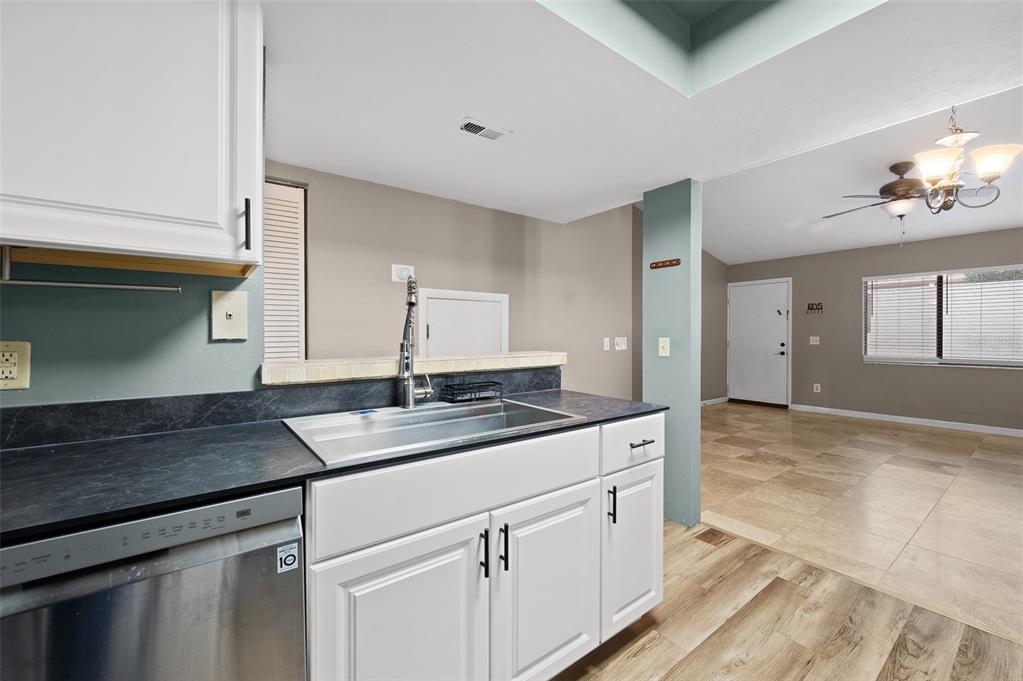 2508 Southwest 35th Place, Unit 51 Gainesville, FL 32608 - Photo 4 of 20 a kitchen with granite countertop a sink and cabinets