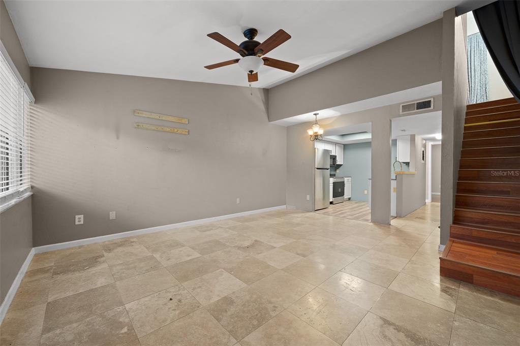 2508 Southwest 35th Place, Unit 151 Gainesville, FL 32608 - Photo 8 of 19 wooden floor in an empty room and a ceiling fan