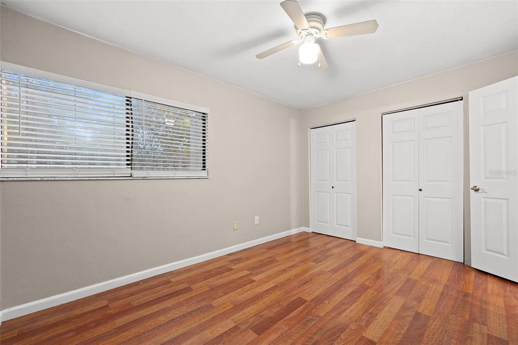2508 Southwest 35th Place, Unit 151 Gainesville, FL 32608 - Photo 10 of 19 a view of empty room with wooden floor and fan
