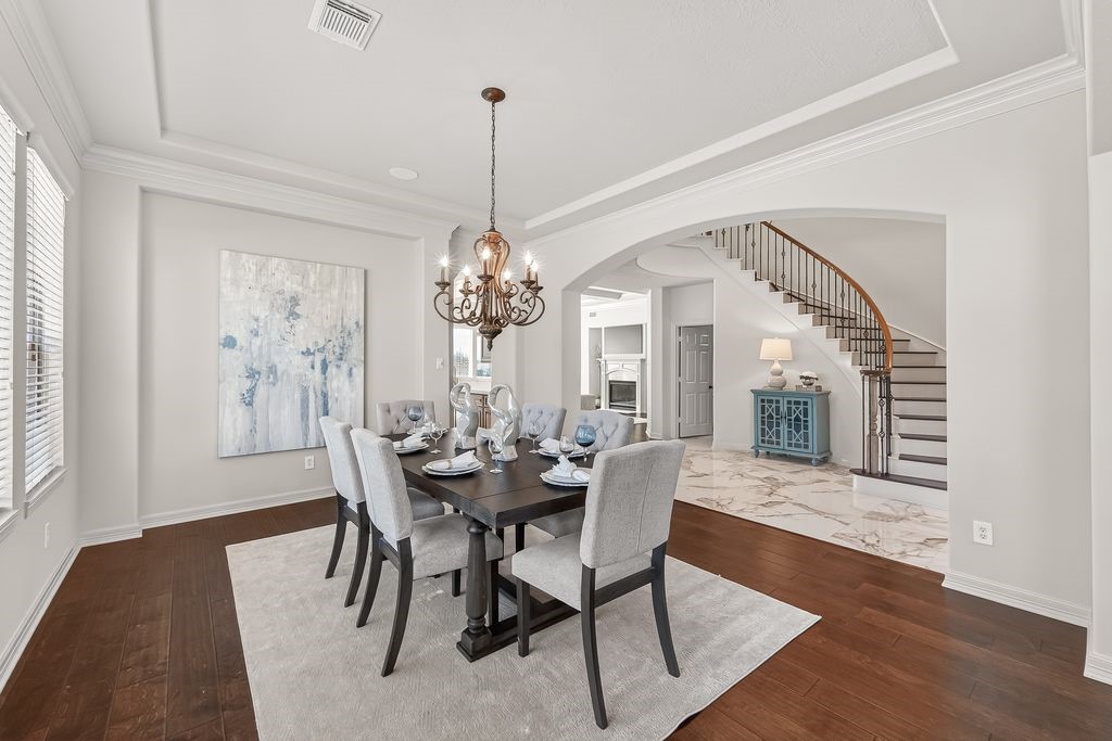 8115 Salta Verde Point Katy, TX 77494 - Photo 11 of 50 a view of a dining room with furniture window and wooden floor