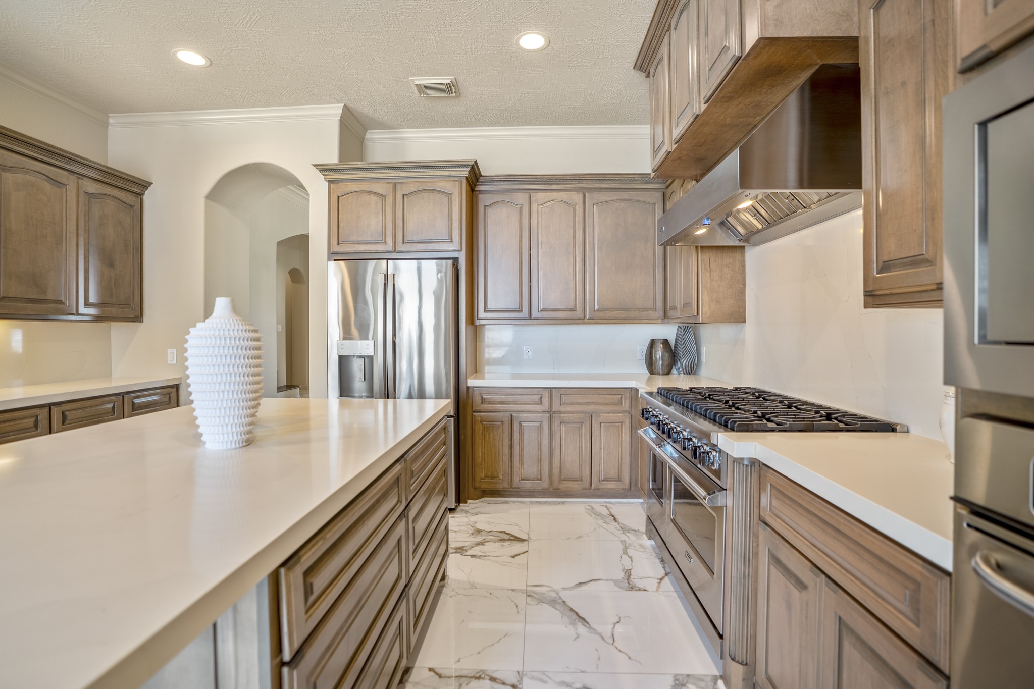 8115 Salta Verde Point Katy, TX 77494 - Photo 21 of 50 a kitchen with granite countertop a stove and a refrigerator