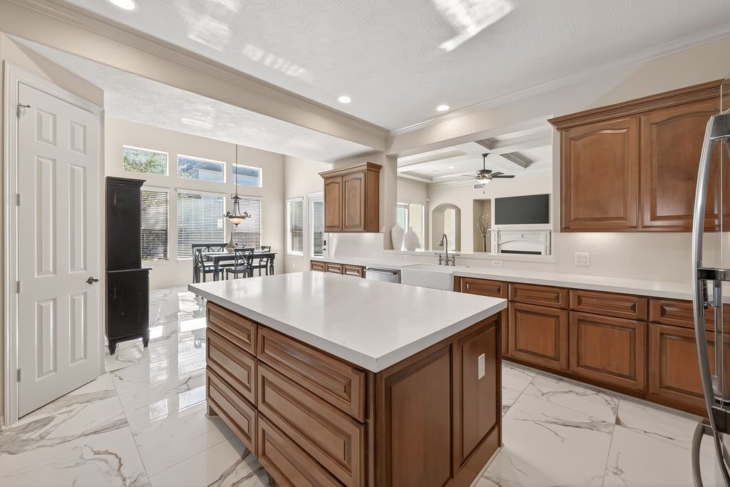 8115 Salta Verde Point Katy, TX 77494 - Photo 22 of 50 a kitchen with a sink stove and refrigerator