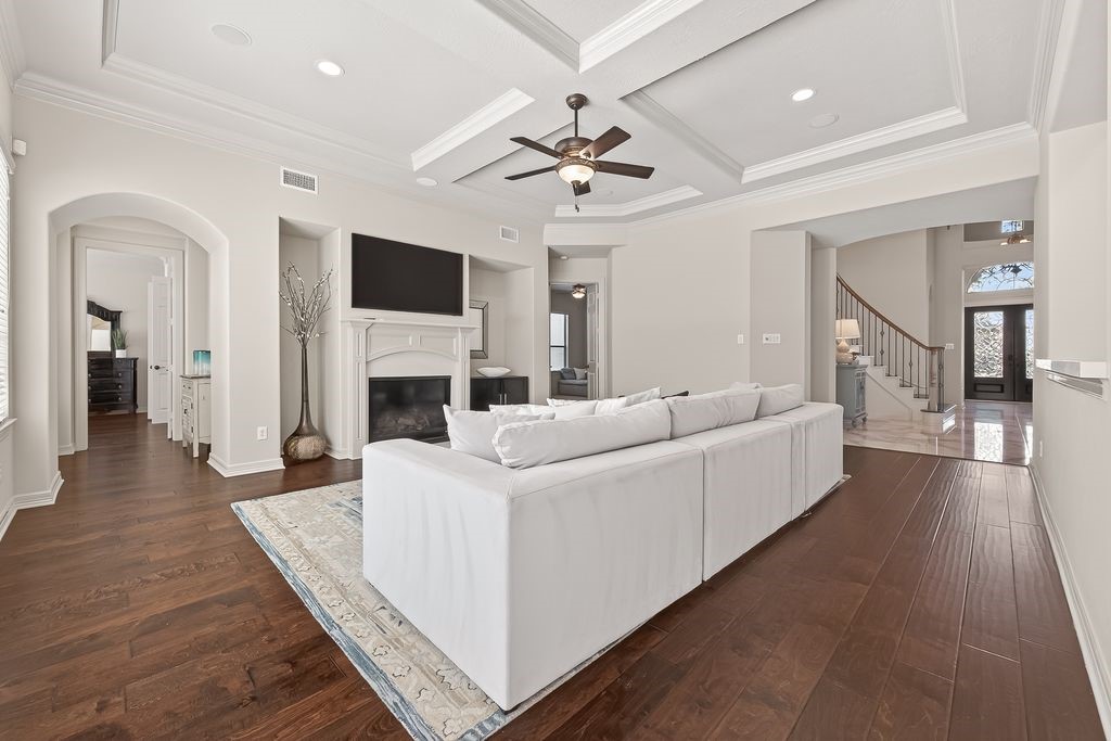 8115 Salta Verde Point Katy, TX 77494 - Photo 26 of 50 a living room with furniture a flat screen tv and a fireplace