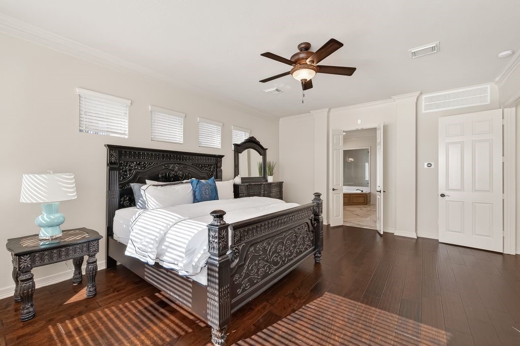 8115 Salta Verde Point Katy, TX 77494 - Photo 28 of 50 a bedroom with a bed and wooden floor
