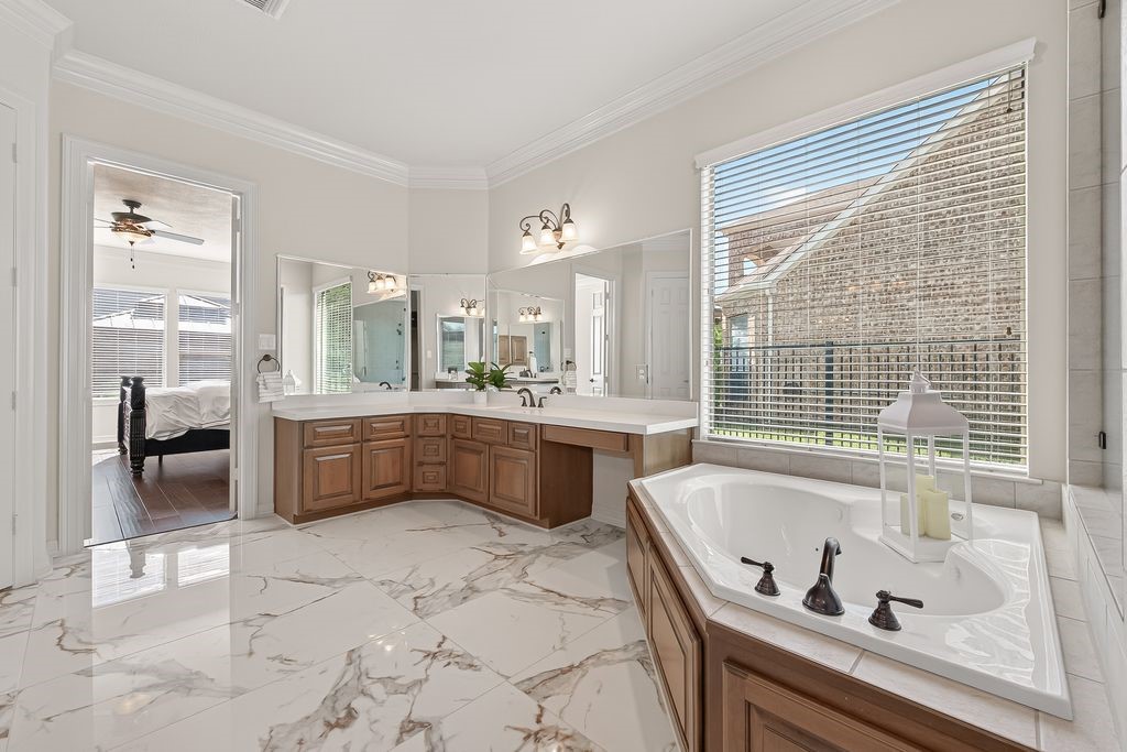 8115 Salta Verde Point Katy, TX 77494 - Photo 29 of 50 a bathroom with a tub a sink and a large window