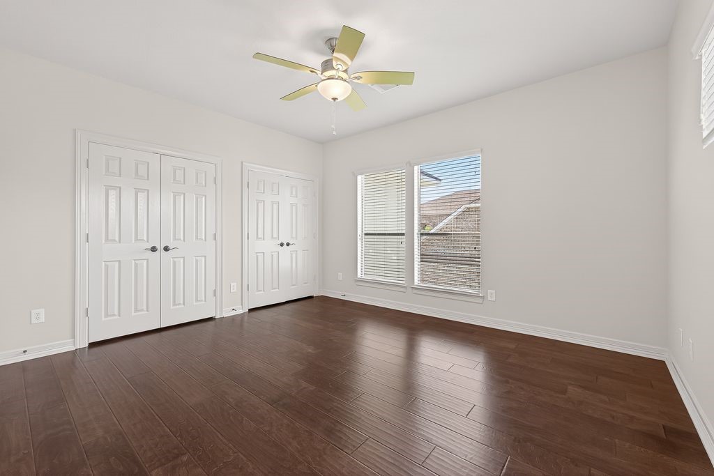 8115 Salta Verde Point Katy, TX 77494 - Photo 39 of 50 a view of an empty room with wooden floor and a window