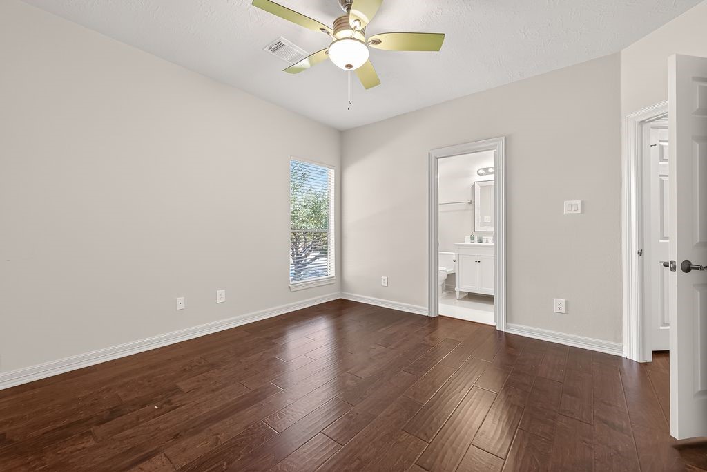 8115 Salta Verde Point Katy, TX 77494 - Photo 40 of 50 an empty room with wooden floor fan and windows