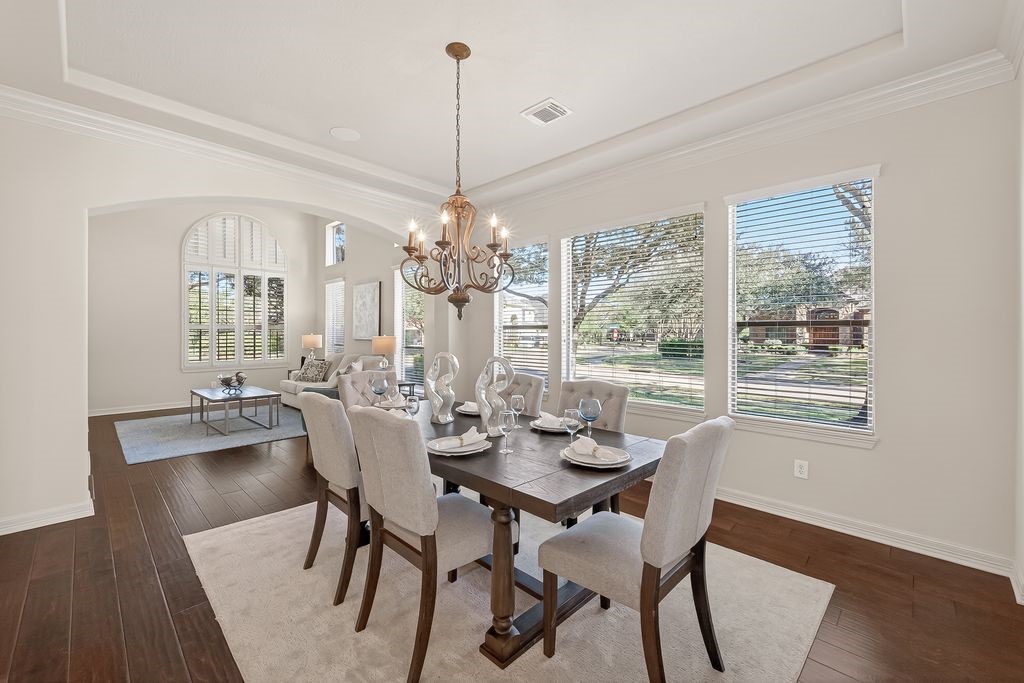 8115 Salta Verde Point Katy, TX 77494 - Photo 4 of 50 a view of a dining room with furniture a chandelier and wooden floor