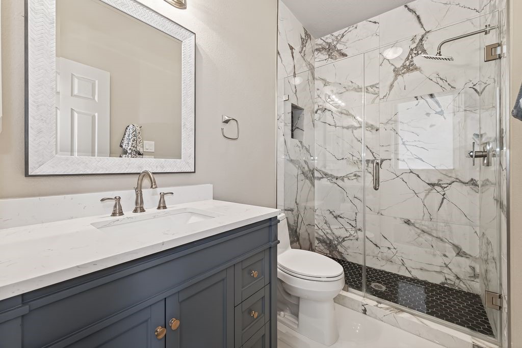 8115 Salta Verde Point Katy, TX 77494 - Photo 43 of 50 a bathroom with a granite countertop sink a toilet and a mirror
