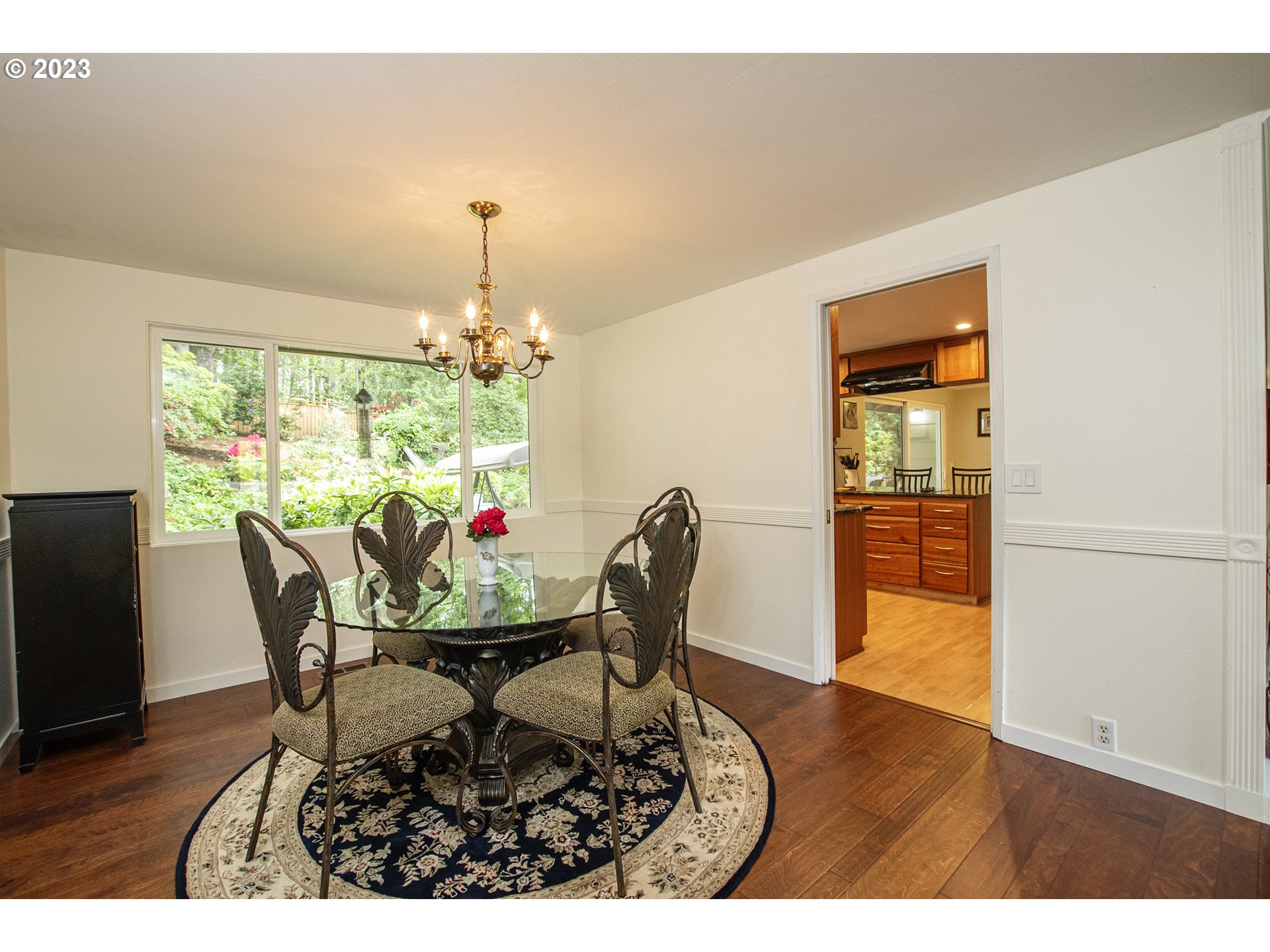 197 Brae Burn Drive Eugene, OR 97405 - Photo 11 of 42 a dining room with furniture a large window and wooden floor