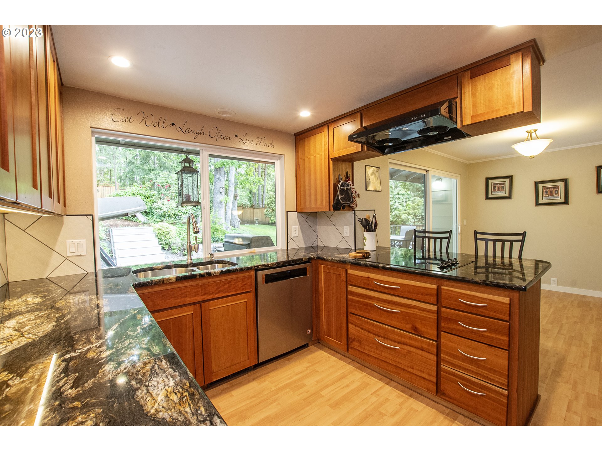 197 Brae Burn Drive Eugene, OR 97405 - Photo 12 of 42 a kitchen with stainless steel appliances granite countertop a sink and wooden cabinets