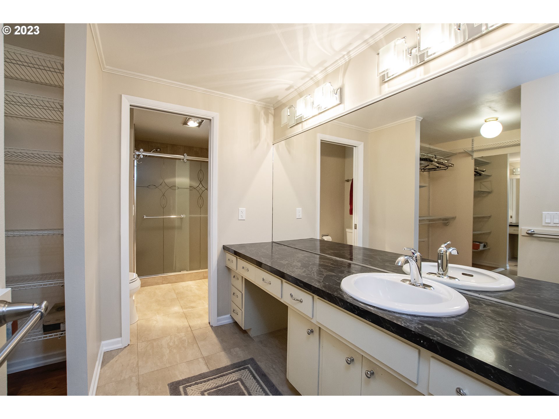 197 Brae Burn Drive Eugene, OR 97405 - Photo 22 of 42 a bathroom with a granite countertop sink a mirror and a shower