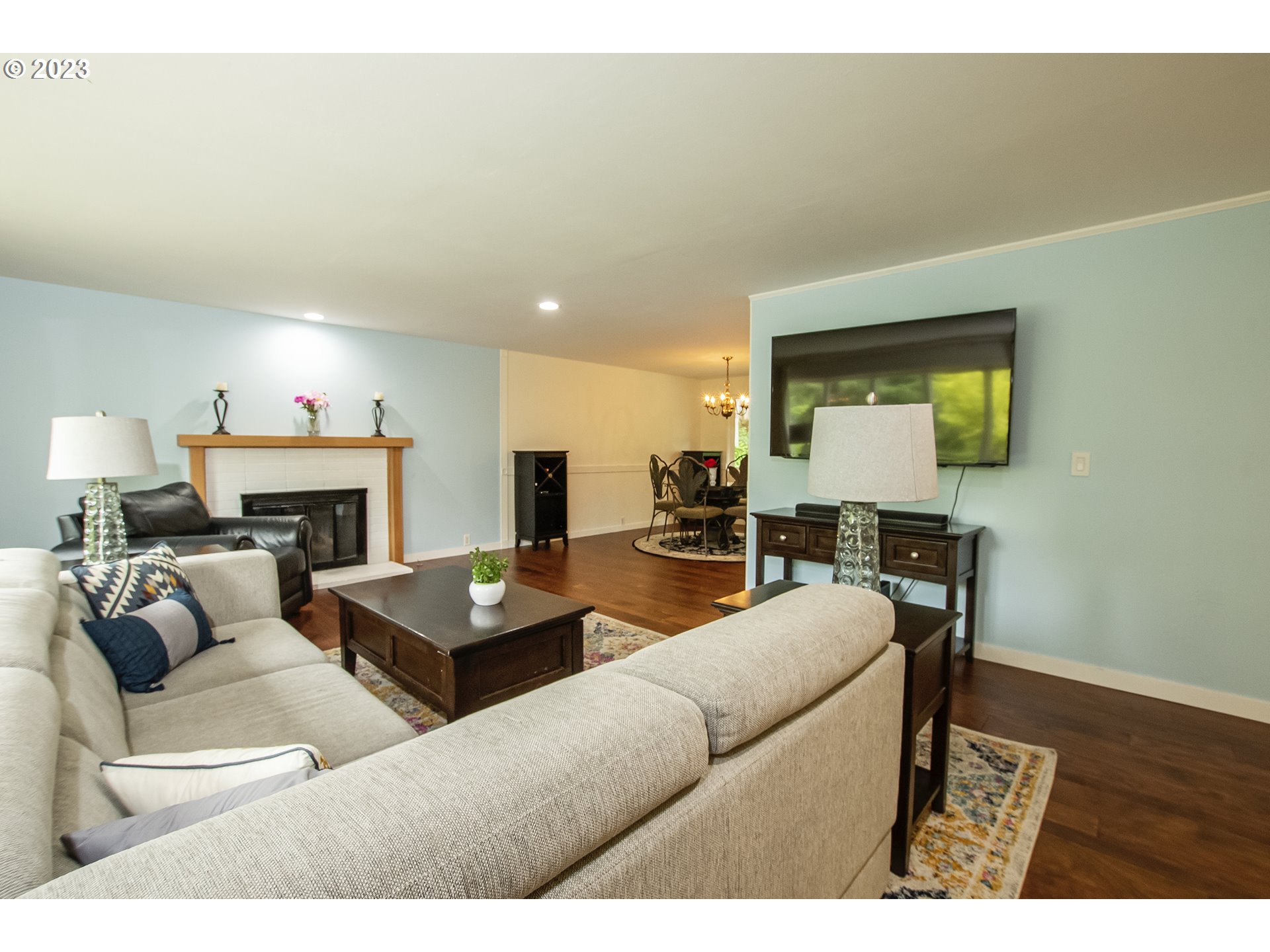 197 Brae Burn Drive Eugene, OR 97405 - Photo 8 of 42 a living room with furniture a fireplace a rug and a window
