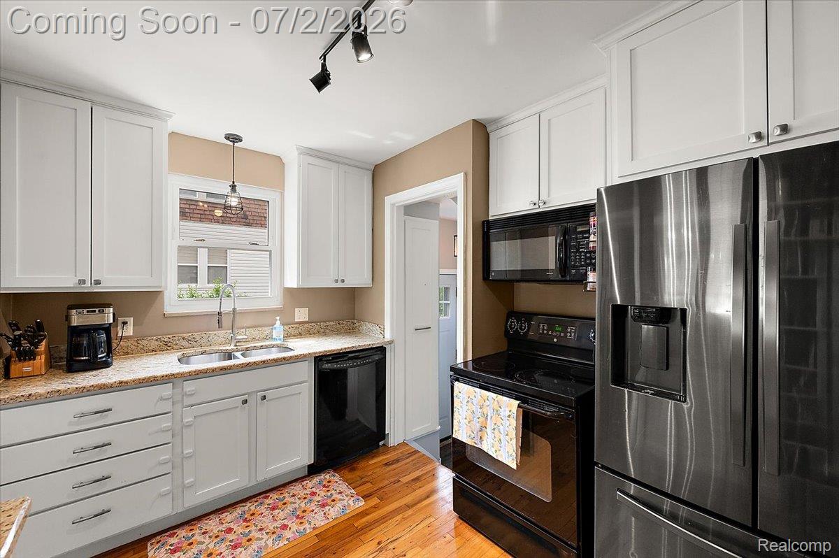 1706 Princeton Road Berkley, MI 48072 - Photo 16 of 49 Kitchen featuring light-toned cabinetry, stainless steel appliances, granite countertops, and wood-finish flooring