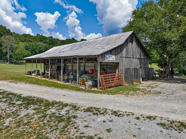 a backyard of a house with yard and outdoor seating