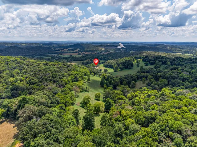 a bed room with a bed and a large window