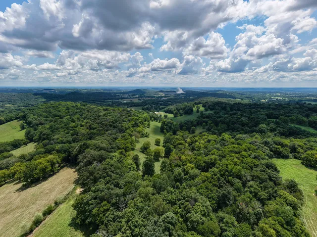 a view of a dining room and hall with furniture
