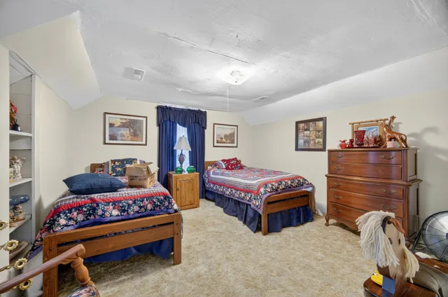 a view of a dining room with furniture and a chandelier