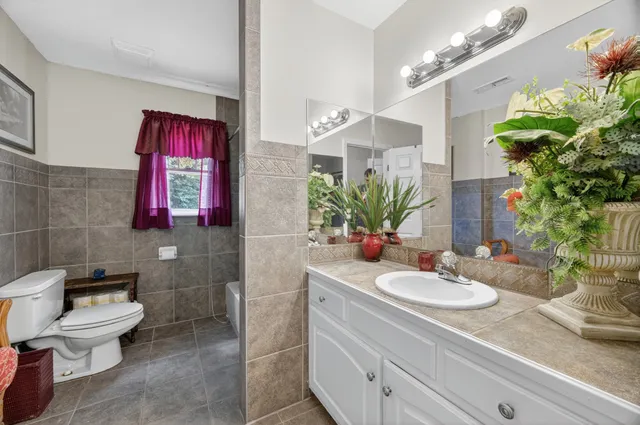 a front view of house with a garden and patio