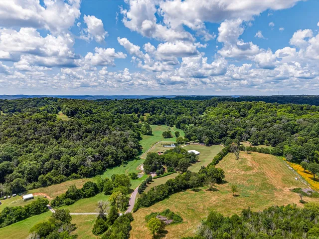a view of a house with a yard and garden