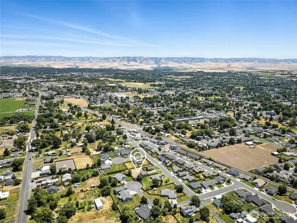 an aerial view of residential houses with outdoor space