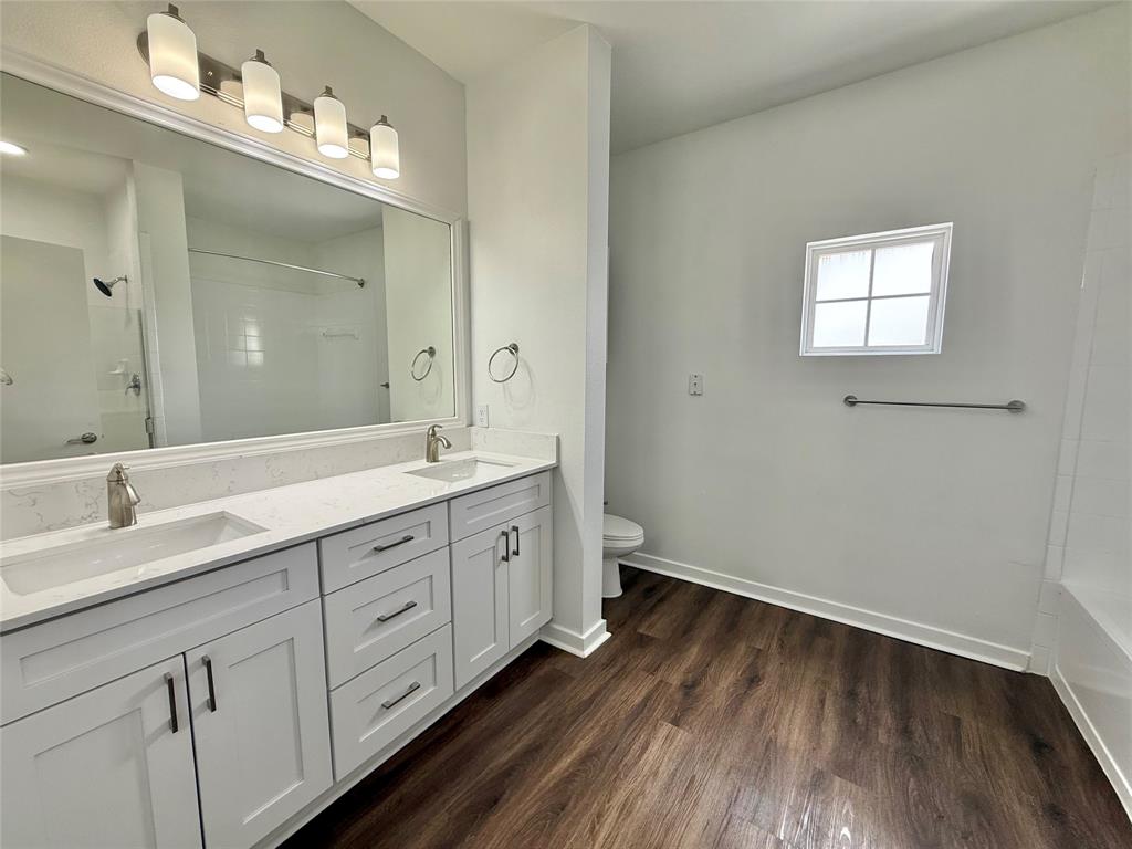 6740 Windhaven Parkway, Unit 5907 The Colony, TX 75056 - Photo 16 of 20 a spacious bathroom with double vanity sink a mirror and a window