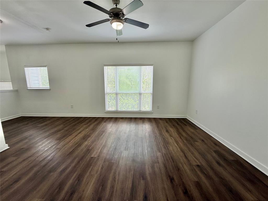 6740 Windhaven Parkway, Unit 5907 The Colony, TX 75056 - Photo 18 of 20 wooden floor in an empty room with a window