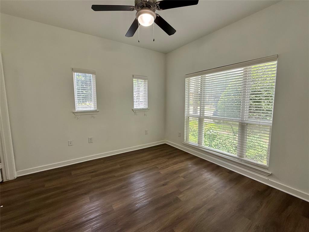 6740 Windhaven Parkway, Unit 5907 The Colony, TX 75056 - Photo 3 of 20 a view of an empty room with wooden floor and a window